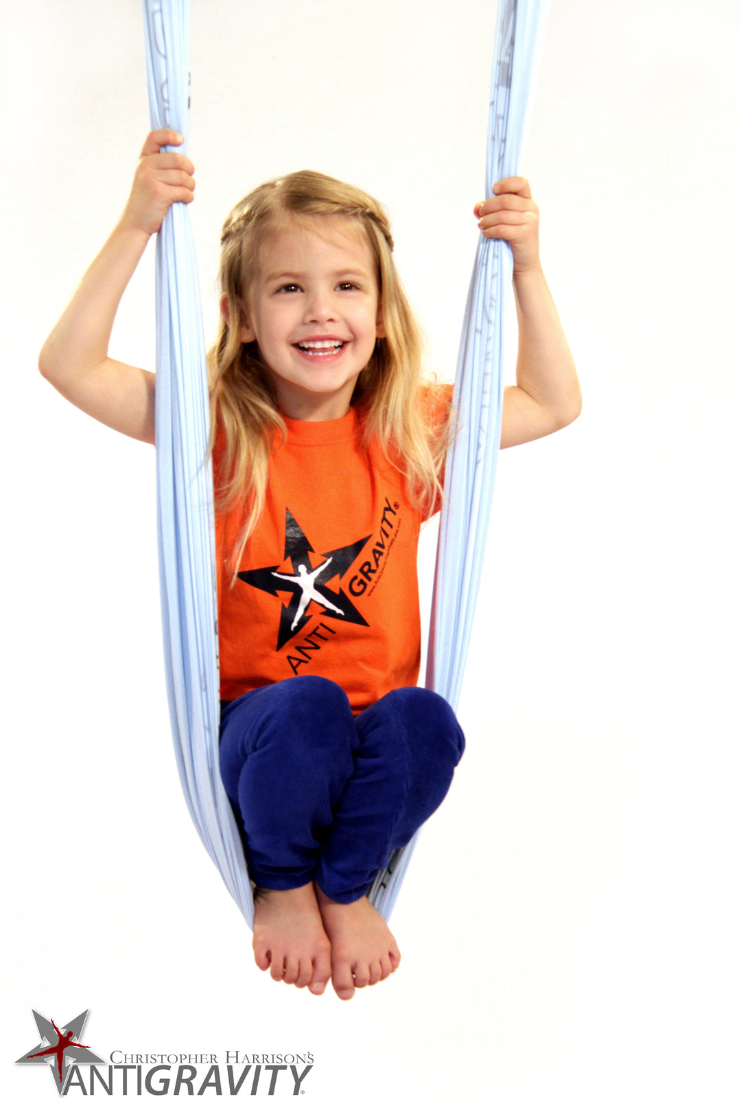 Child sitting in an Antigravity hammock with 'Antigravity' branding on a white background